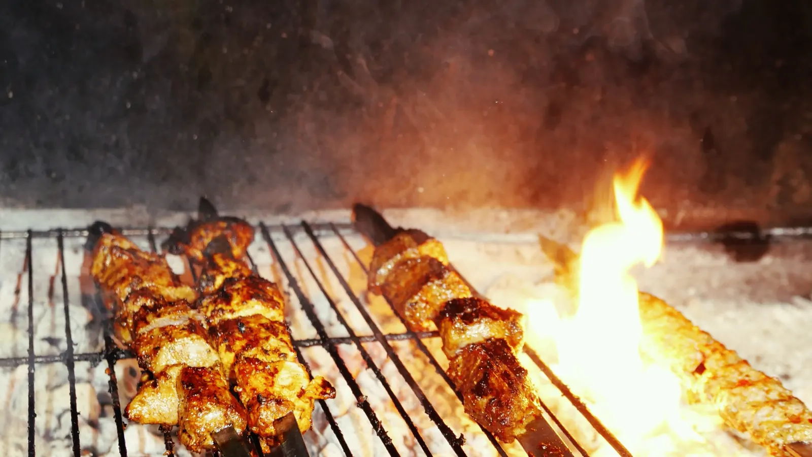 Brochettes sur épée au-dessus des flammes du charbon de bois — grillades à Dunkerque
